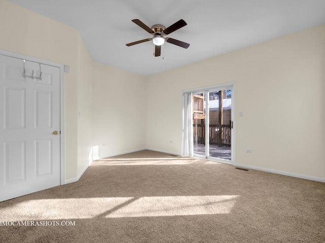 carpeted spare room featuring ceiling fan