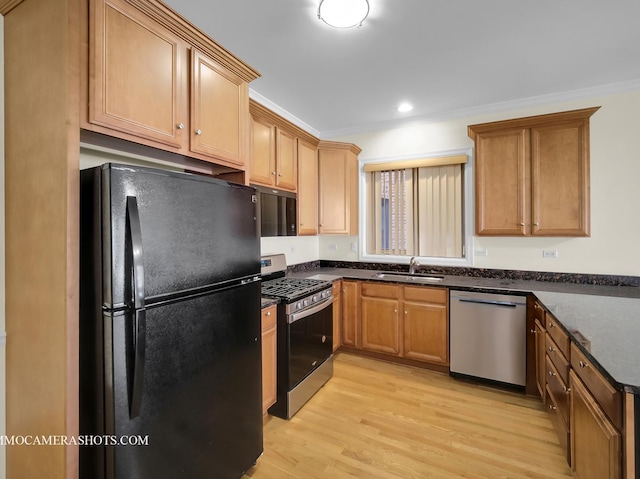 kitchen with light wood-type flooring, black appliances, sink, dark stone countertops, and crown molding