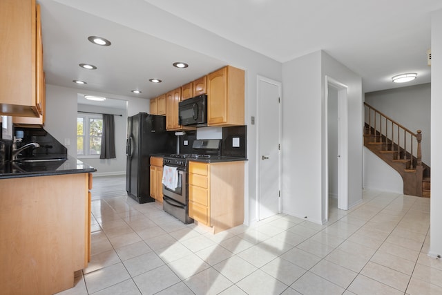 kitchen with backsplash, light tile patterned floors, light brown cabinetry, black appliances, and sink