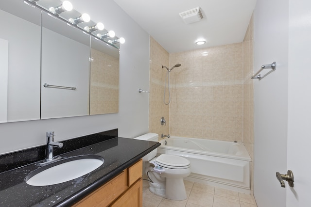 full bathroom with vanity, toilet, tiled shower / bath combo, and tile patterned flooring