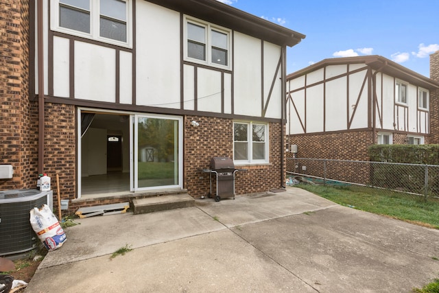 back of property featuring a patio and central AC