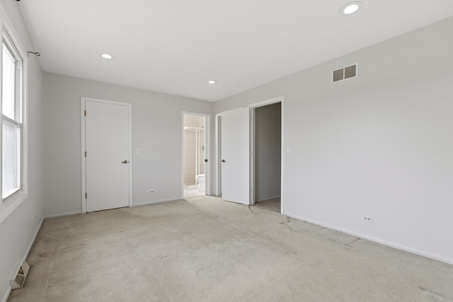 carpeted empty room with a healthy amount of sunlight