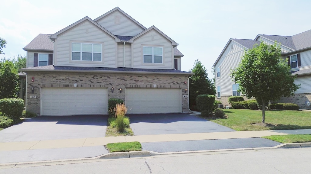 view of front of house featuring a garage and a front lawn