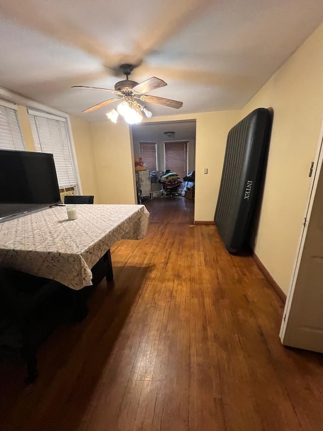 bedroom featuring ceiling fan and dark hardwood / wood-style flooring