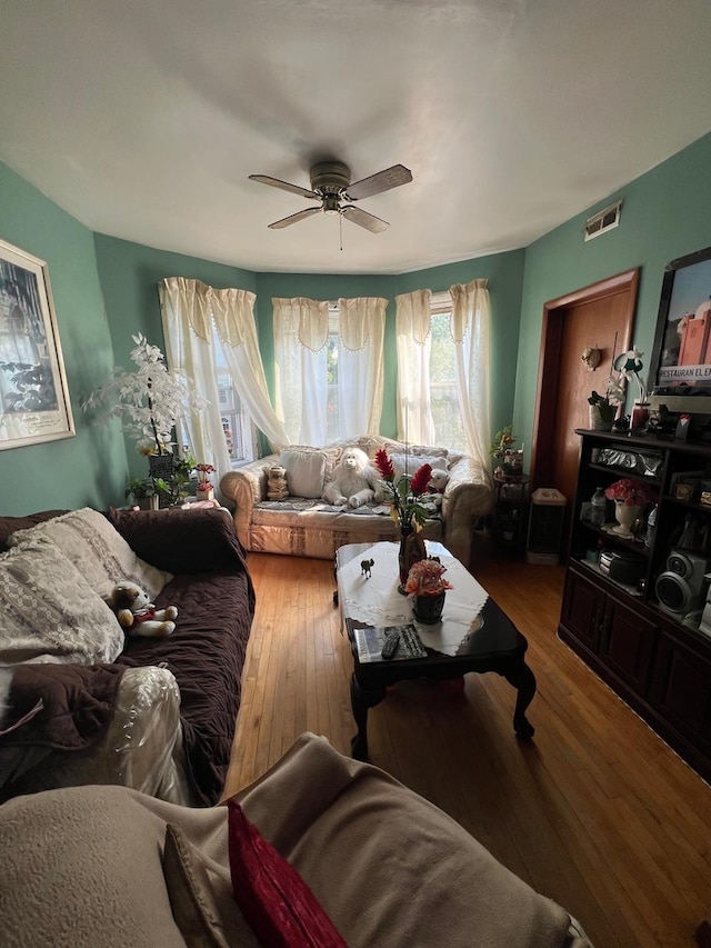 living room with ceiling fan and hardwood / wood-style floors