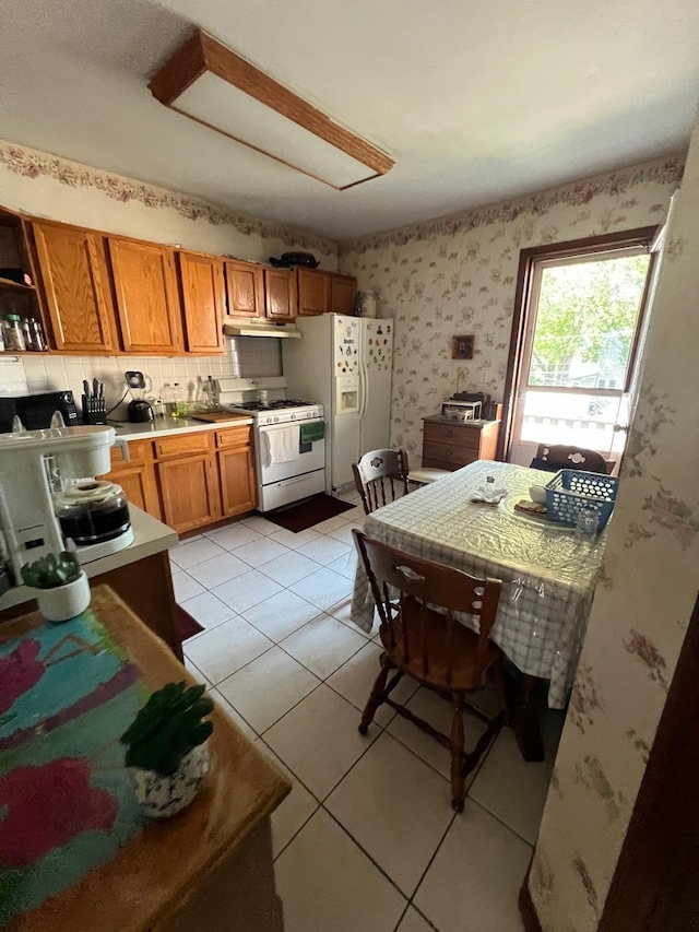 kitchen with white appliances and light tile patterned flooring