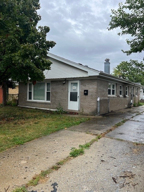 4327 Eberly Ave, Brookfield, IL 60513 - view of front facade with brick siding and a chimney