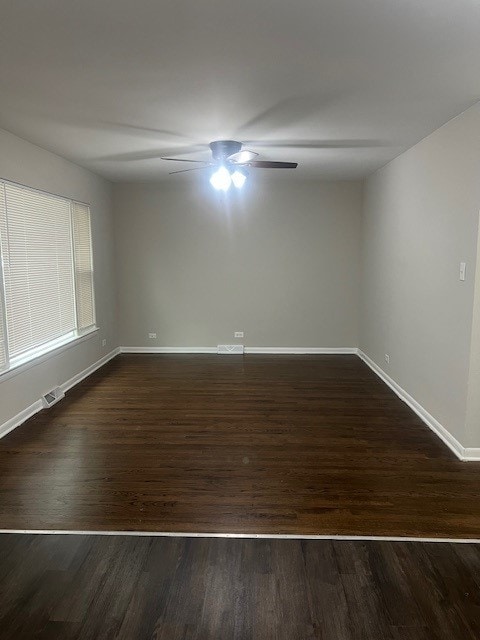 4327 Eberly Ave, Brookfield, IL 60513 - unfurnished room featuring baseboards, dark wood-style flooring, visible vents, and a ceiling fan