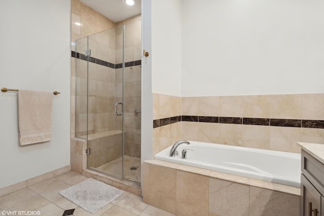 bathroom with plus walk in shower, tile patterned flooring, and vanity