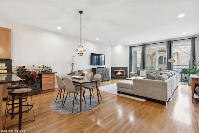 living room with light wood-type flooring and a fireplace