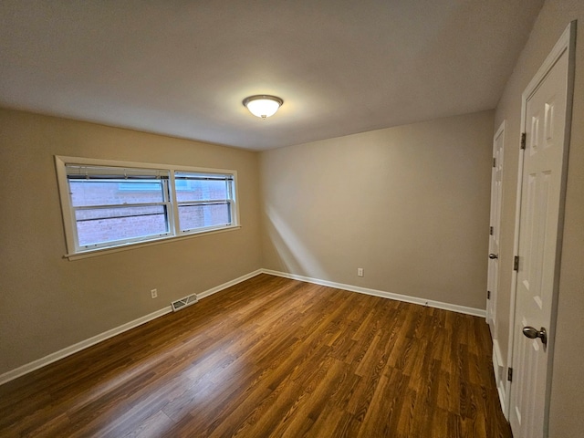 spare room featuring dark hardwood / wood-style floors