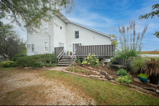 back of house with a wooden deck