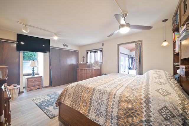 bedroom featuring light wood-type flooring and ceiling fan