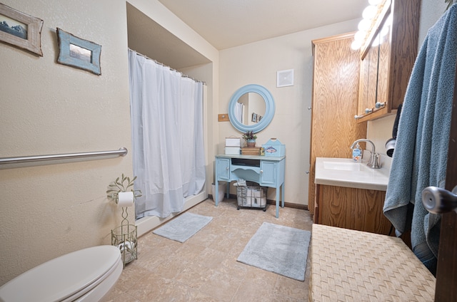 bathroom with walk in shower, vanity, and toilet