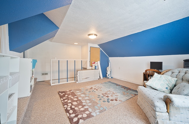 carpeted bedroom with a textured ceiling and lofted ceiling