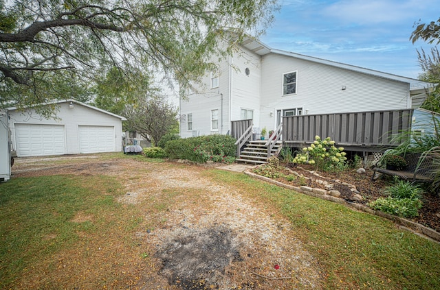 view of yard with an outdoor structure, a deck, and a garage