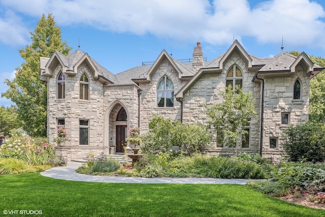 french provincial home with a front lawn