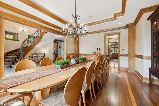 dining room featuring ornamental molding, a tray ceiling, dark hardwood / wood-style floors, and a notable chandelier