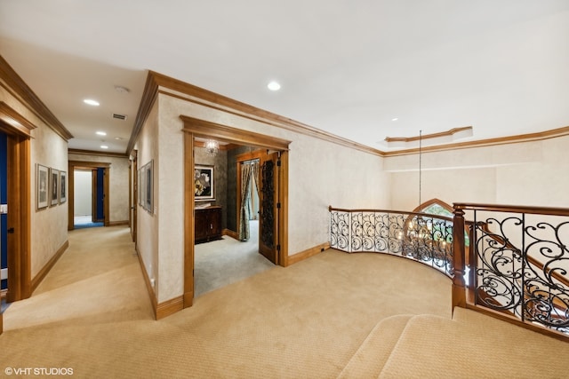 corridor featuring light colored carpet and crown molding