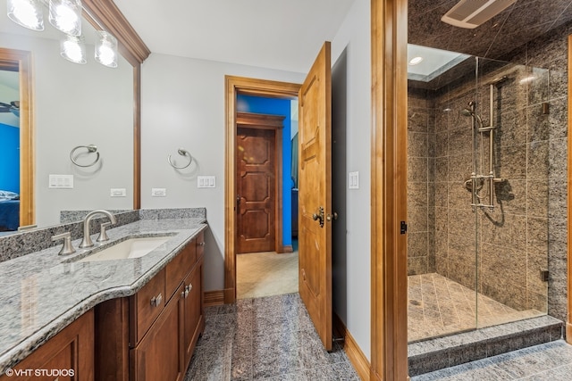 bathroom with walk in shower and vanity