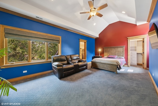 carpeted bedroom with ceiling fan, a closet, vaulted ceiling, and a walk in closet