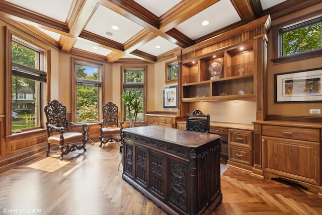 home office featuring built in desk, coffered ceiling, beamed ceiling, and a wealth of natural light