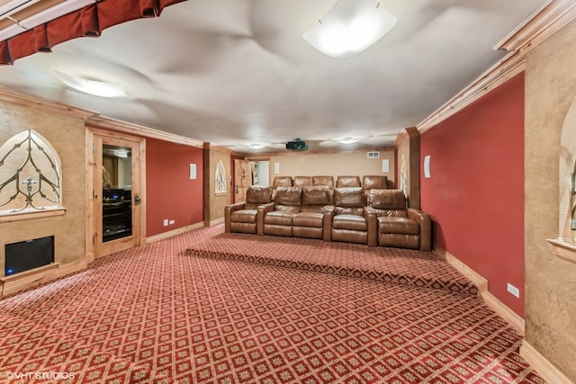 cinema room with crown molding and carpet flooring