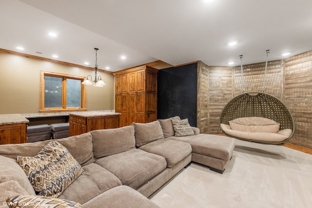 carpeted living room featuring crown molding and a notable chandelier