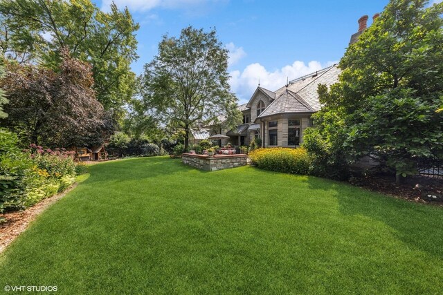 view of patio / terrace with an outdoor living space with a fire pit