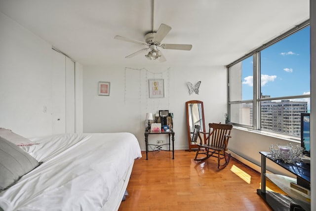 bedroom featuring light wood-type flooring and ceiling fan