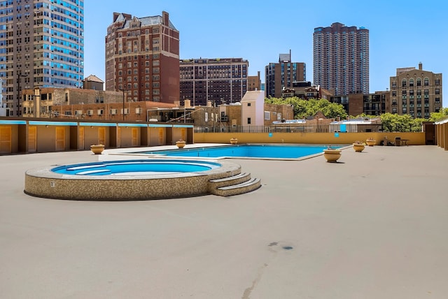 view of swimming pool featuring a community hot tub