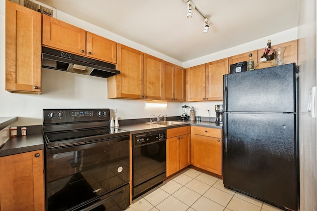 kitchen with track lighting, light tile patterned floors, sink, and black appliances