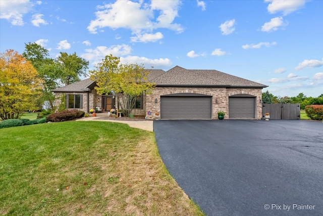 view of front of home featuring a front lawn and a garage