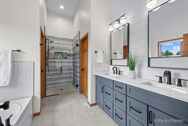 bathroom with shower with separate bathtub, tile patterned floors, and vanity