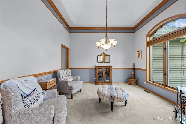 carpeted living room with an inviting chandelier and crown molding