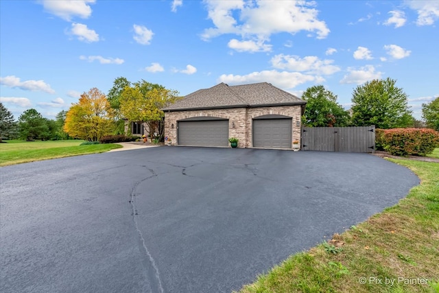 view of front of home featuring a garage and a front yard