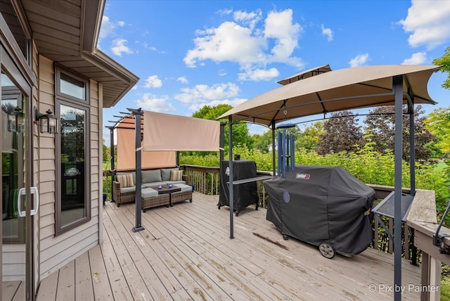 wooden terrace featuring a gazebo, outdoor lounge area, and a grill