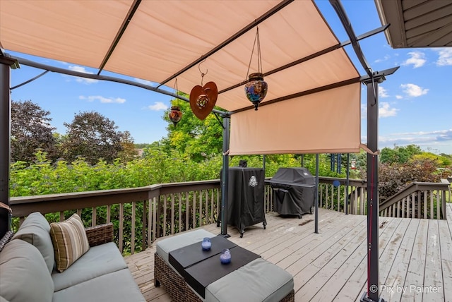 wooden deck with grilling area and an outdoor hangout area