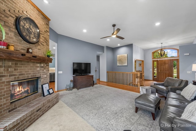 living room with ceiling fan, light colored carpet, and a brick fireplace