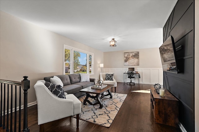 living room with a notable chandelier, sink, and dark wood-type flooring