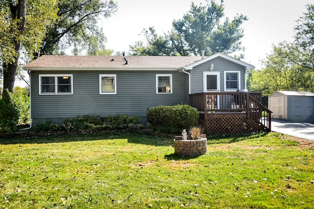 exterior space with a storage shed, a wooden deck, and a lawn