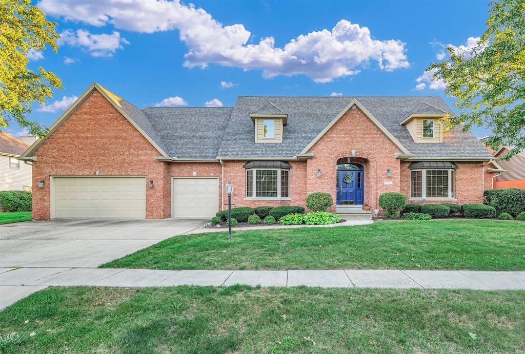 view of front of property with a garage and a front lawn