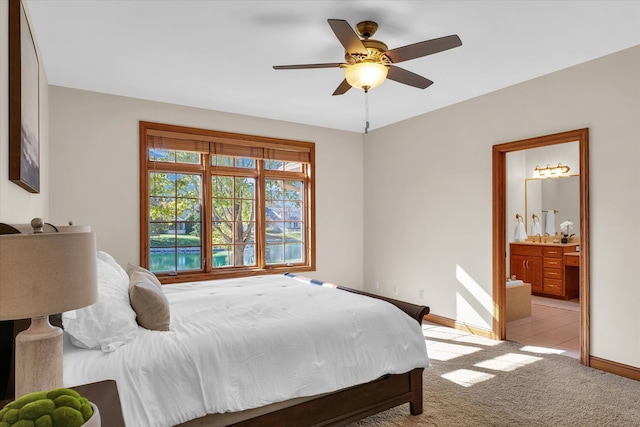 carpeted bedroom with connected bathroom and ceiling fan