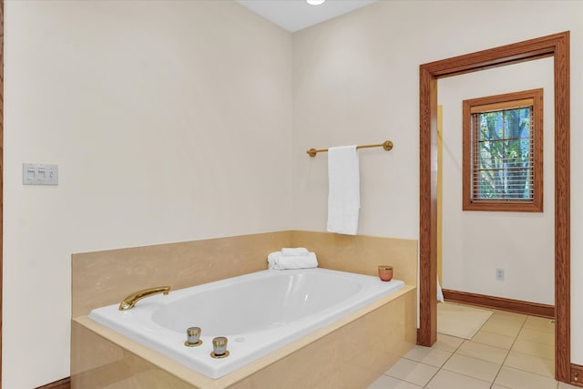 bathroom with tiled tub and tile patterned flooring