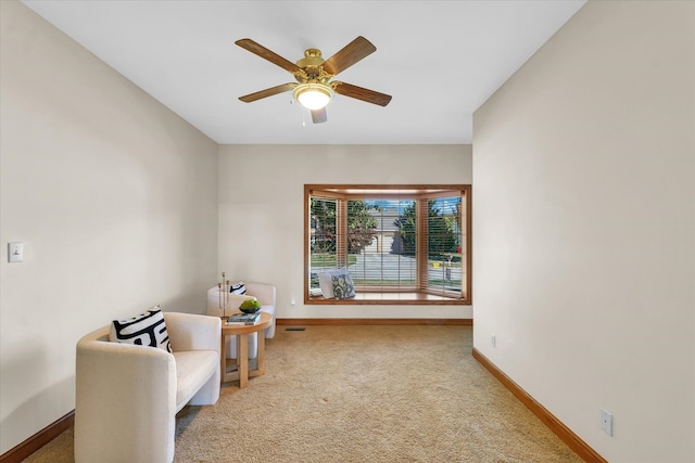 sitting room with carpet and ceiling fan