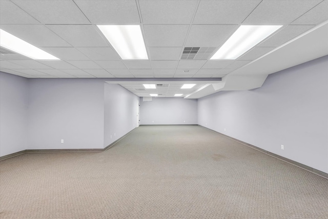 basement featuring a drop ceiling and carpet flooring