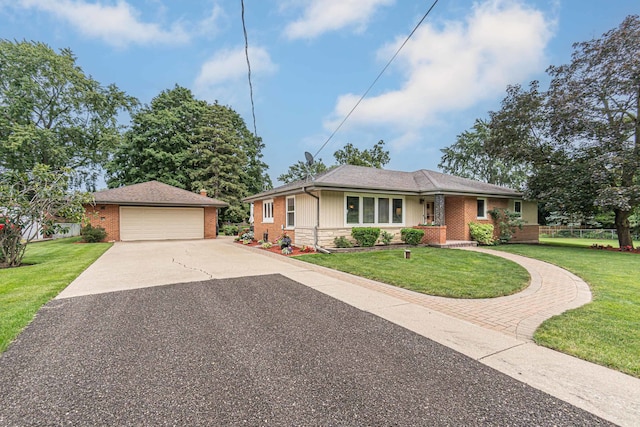 ranch-style home with a front lawn, an outdoor structure, and a garage