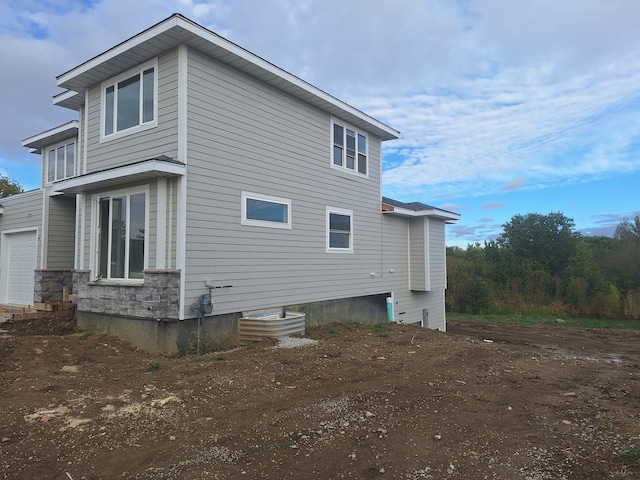 view of side of home with a garage