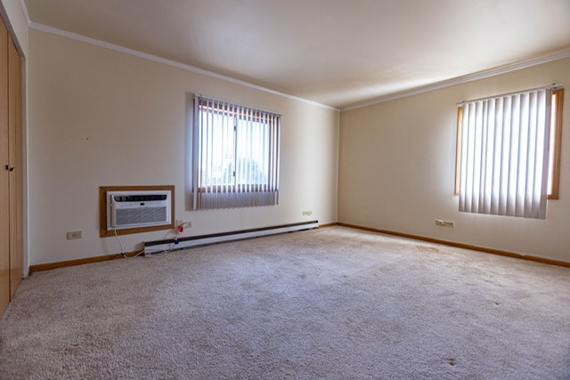 unfurnished room featuring light carpet, crown molding, and a wall unit AC