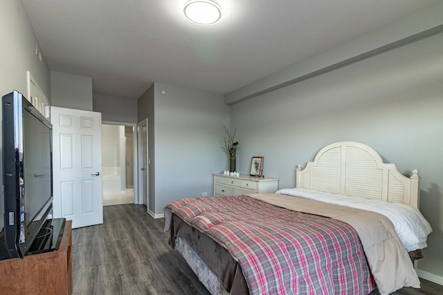 bedroom featuring connected bathroom and dark hardwood / wood-style flooring